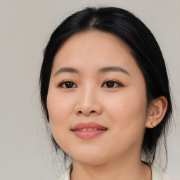 Joyful asian young-adult female with medium  black hair and brown eyes