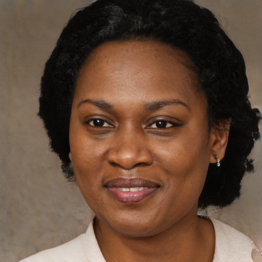 Joyful black adult female with medium  black hair and brown eyes