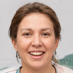 Joyful white adult female with medium  brown hair and brown eyes