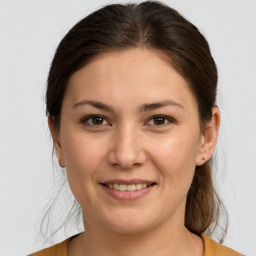 Joyful white young-adult female with medium  brown hair and brown eyes