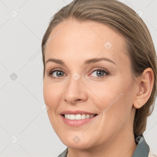 Joyful white young-adult female with long  brown hair and brown eyes