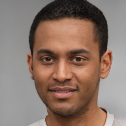 Joyful black young-adult male with short  brown hair and brown eyes