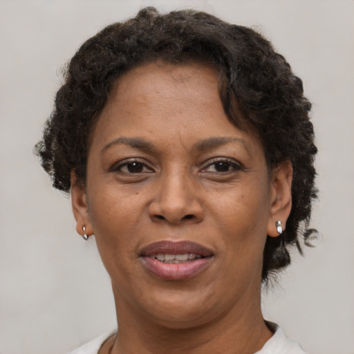 Joyful black adult female with short  brown hair and brown eyes
