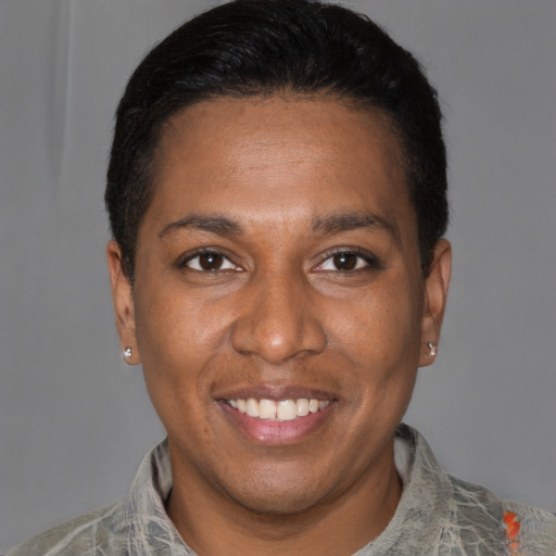 Joyful latino young-adult female with short  black hair and brown eyes