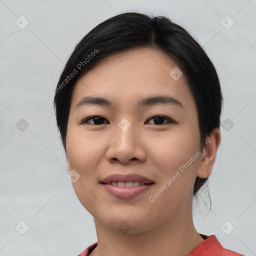 Joyful asian young-adult female with short  black hair and brown eyes