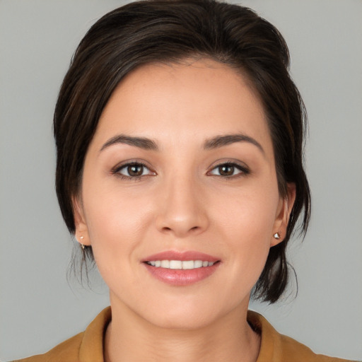 Joyful white young-adult female with medium  brown hair and brown eyes