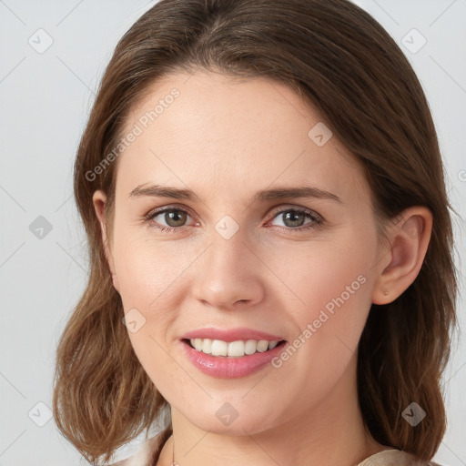 Joyful white young-adult female with medium  brown hair and grey eyes