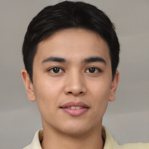 Joyful asian young-adult male with short  brown hair and brown eyes