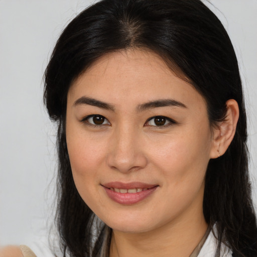 Joyful white young-adult female with long  brown hair and brown eyes