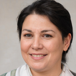 Joyful white adult female with medium  brown hair and brown eyes