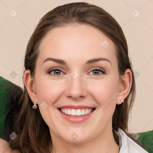 Joyful white young-adult female with medium  brown hair and grey eyes