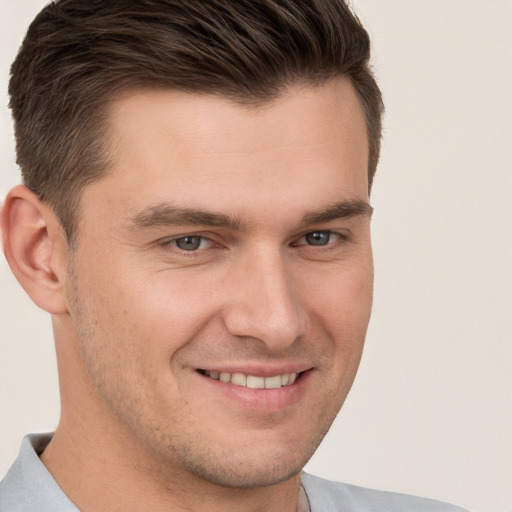 Joyful white young-adult male with short  brown hair and brown eyes