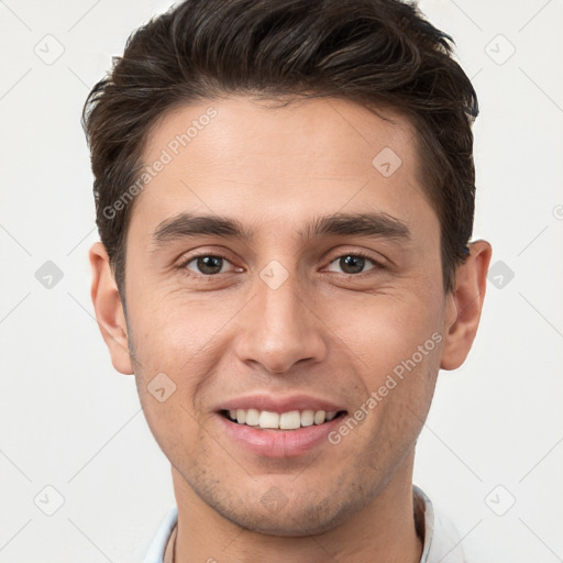 Joyful white young-adult male with short  brown hair and brown eyes