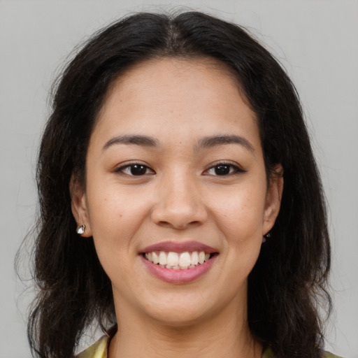 Joyful asian young-adult female with long  brown hair and brown eyes