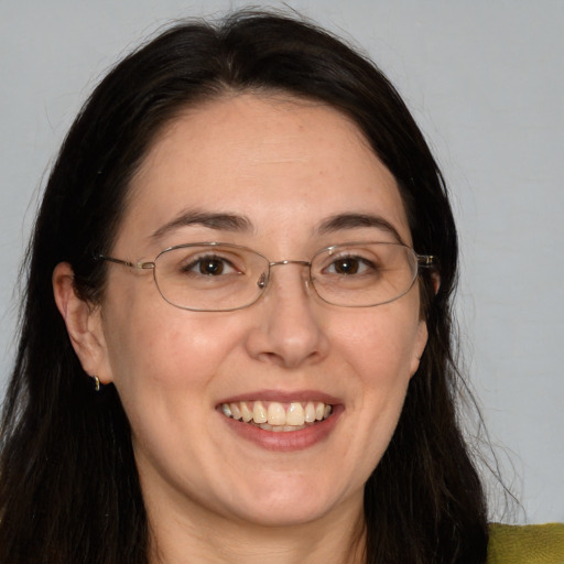 Joyful white adult female with long  brown hair and brown eyes