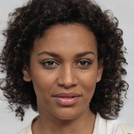 Joyful black young-adult female with medium  brown hair and brown eyes