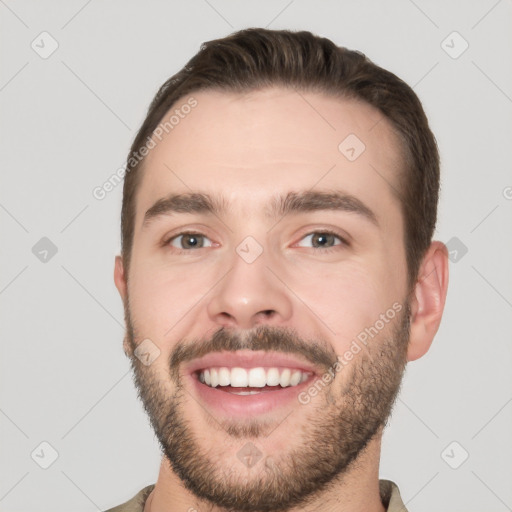 Joyful white young-adult male with short  brown hair and brown eyes