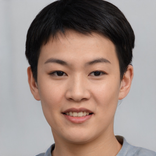 Joyful asian young-adult female with short  black hair and brown eyes