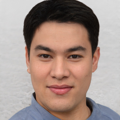 Joyful asian young-adult male with short  black hair and brown eyes