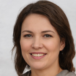 Joyful white young-adult female with medium  brown hair and brown eyes