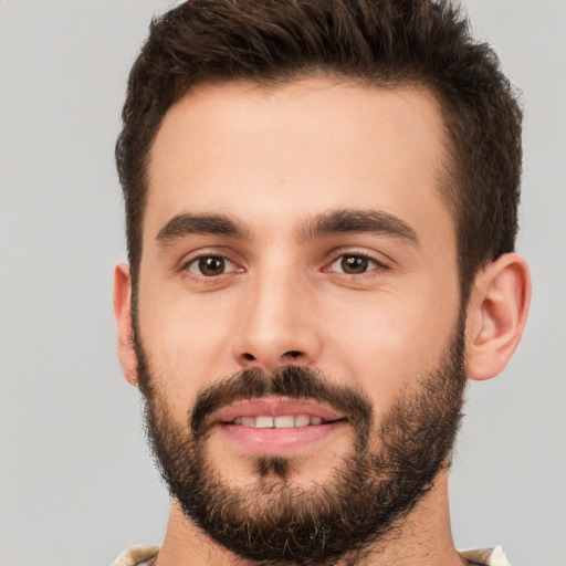 Joyful white young-adult male with short  brown hair and brown eyes