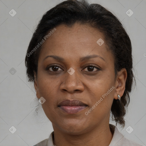 Joyful black adult female with medium  brown hair and brown eyes