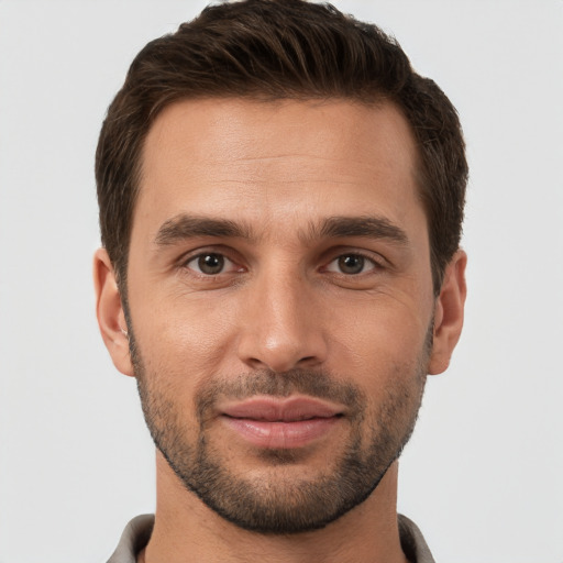 Joyful white young-adult male with short  brown hair and brown eyes