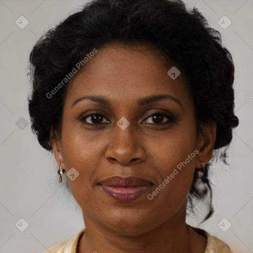 Joyful black adult female with medium  brown hair and brown eyes