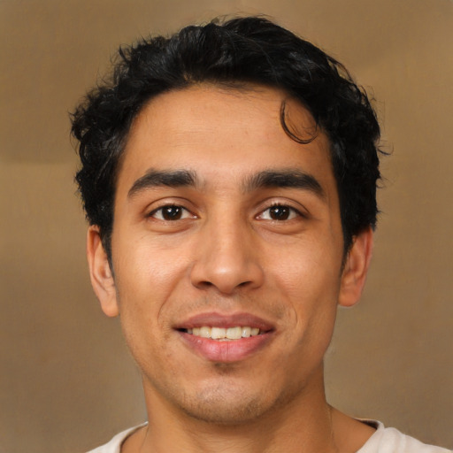 Joyful latino young-adult male with short  brown hair and brown eyes