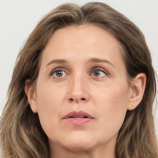 Joyful white adult female with long  brown hair and brown eyes