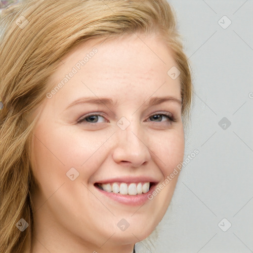 Joyful white young-adult female with long  brown hair and blue eyes