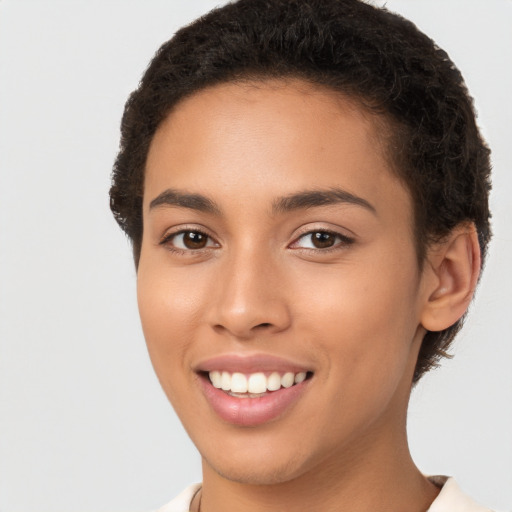 Joyful latino young-adult female with short  brown hair and brown eyes