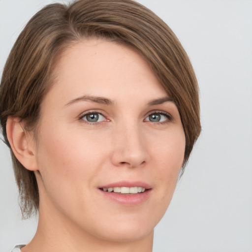 Joyful white young-adult female with medium  brown hair and green eyes