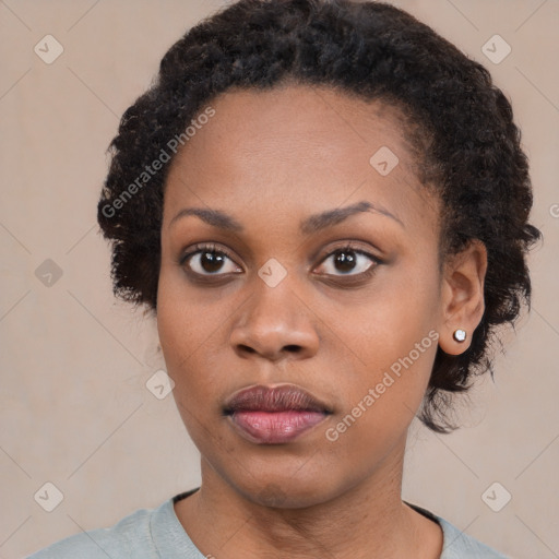 Joyful black young-adult female with medium  black hair and brown eyes