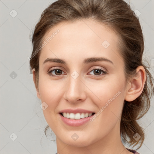 Joyful white young-adult female with medium  brown hair and grey eyes