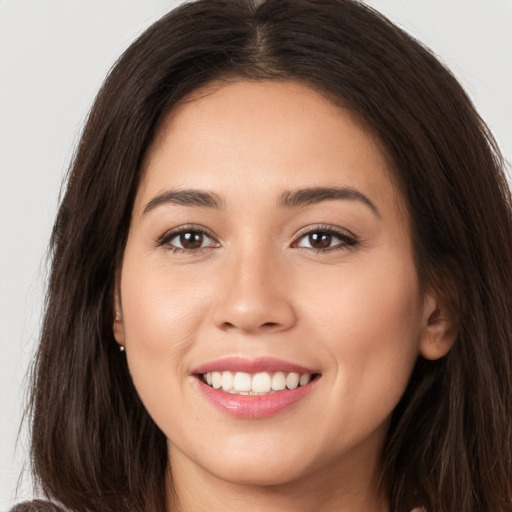 Joyful white young-adult female with long  brown hair and brown eyes