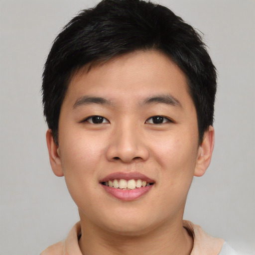 Joyful asian young-adult male with short  black hair and brown eyes