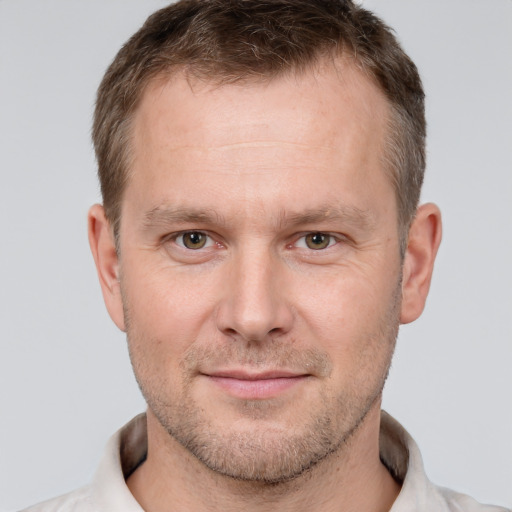 Joyful white adult male with short  brown hair and brown eyes