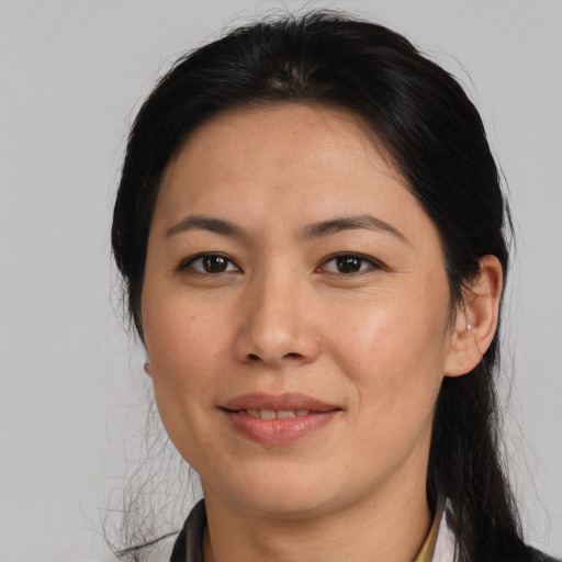 Joyful asian adult female with medium  brown hair and brown eyes