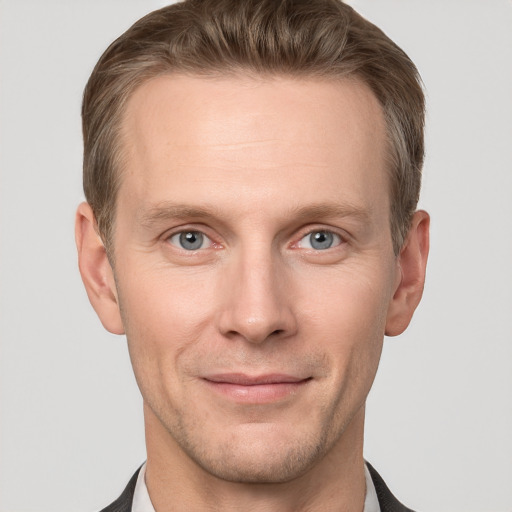 Joyful white adult male with short  brown hair and grey eyes