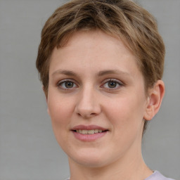 Joyful white young-adult female with short  brown hair and grey eyes