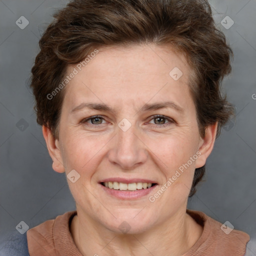 Joyful white adult female with short  brown hair and grey eyes