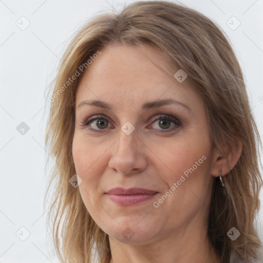 Joyful white adult female with long  brown hair and brown eyes