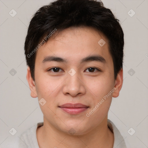 Joyful asian young-adult male with short  brown hair and brown eyes