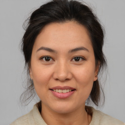 Joyful asian young-adult female with medium  brown hair and brown eyes