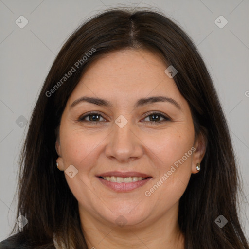 Joyful white adult female with long  brown hair and brown eyes