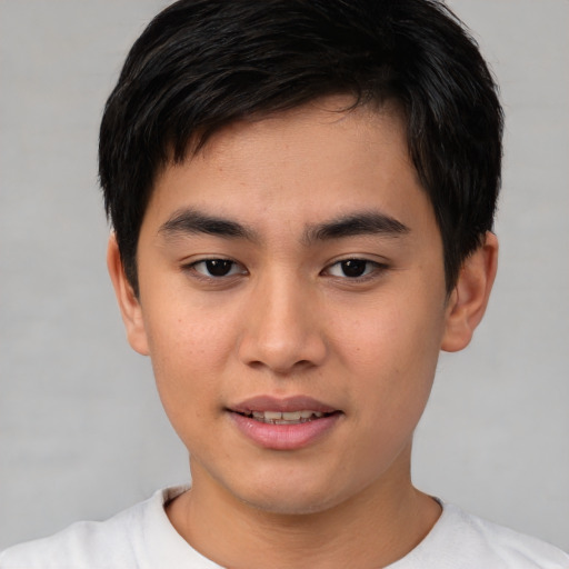 Joyful asian young-adult male with short  brown hair and brown eyes
