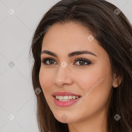 Joyful white young-adult female with long  brown hair and brown eyes