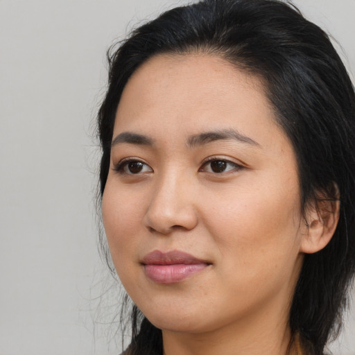 Joyful asian young-adult female with long  brown hair and brown eyes