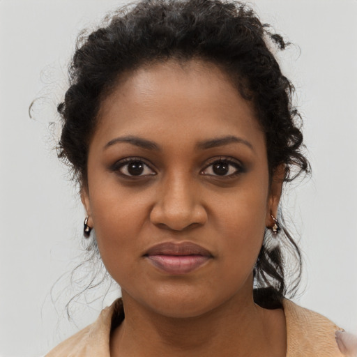 Joyful black young-adult female with medium  brown hair and brown eyes